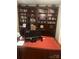 Home office with a custom, built-in bookshelf filled with books and decorative items at 1832 Marthas Vineyard Rd, York, SC 29745