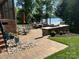 Outdoor patio space with stone walls, grill, lake views, and ample seating for entertaining at 1832 Marthas Vineyard Rd, York, SC 29745