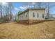 Exterior of home showing siding, green roof, windows, and brick foundation on sloped lot at 1921 Woodridge Dr, Hickory, NC 28602