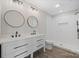 Bathroom featuring double sink vanity, modern fixtures, and a tiled shower at 1921 Woodridge Dr, Hickory, NC 28602