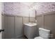 Powder room features vanity with updated fixtures and stylish wallpaper at 1921 Woodridge Dr, Hickory, NC 28602