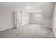 Large bedroom with neutral paint, carpet, an open door, and natural light from a window at 1921 Woodridge Dr, Hickory, NC 28602