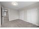 Carpeted bedroom featuring a window and two closets at 1921 Woodridge Dr, Hickory, NC 28602