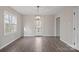 Bright dining room with natural light and an elegant light fixture, complementing the wood look floors at 1921 Woodridge Dr, Hickory, NC 28602