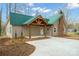 Charming home with a green metal roof, covered porch with wood supports and a spacious driveway at 1921 Woodridge Dr, Hickory, NC 28602