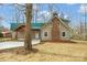 Charming home with a green roof, brick chimney, and freshly poured driveway at 1921 Woodridge Dr, Hickory, NC 28602