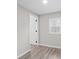 Hallway featuring a window, white door, and hardwood floors at 1921 Woodridge Dr, Hickory, NC 28602