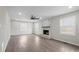Bright living room featuring a painted brick fireplace, ceiling fan, and large windows for natural light at 1921 Woodridge Dr, Hickory, NC 28602