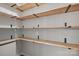 Walk-in pantry featuring open wood shelving with black metal brackets at 1921 Woodridge Dr, Hickory, NC 28602