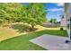 Expansive backyard with lush green grass, mature trees, and privacy fence, offering plenty of space for outdoor activities at 1923 Caprington Dr, Fort Mill, SC 29707