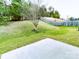 Large backyard featuring a green lawn, a small tree, a patio and a wooden fence at 1923 Caprington Dr, Fort Mill, SC 29707