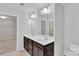 Stylish bathroom featuring double sinks, vanity lighting, and a large mirror and doorway to another space at 1923 Caprington Dr, Fort Mill, SC 29707
