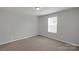 Bright bedroom with neutral carpet, gray walls, and natural light from the window at 1923 Caprington Dr, Fort Mill, SC 29707