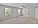 Inviting bedroom featuring soft carpeting, ceiling fan, and windows providing ample natural light and comfortable space at 1923 Caprington Dr, Fort Mill, SC 29707