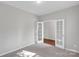 Neutral bedroom with carpet and open french doors leading to hardwood hallway at 1923 Caprington Dr, Fort Mill, SC 29707