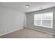 Neutral bedroom with large window, carpet, and modern light fixture at 1923 Caprington Dr, Fort Mill, SC 29707