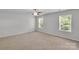 Serene bedroom with carpet, natural light, and modern ceiling fan offers a comfortable and relaxing private space at 1923 Caprington Dr, Fort Mill, SC 29707