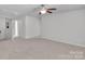 Bright bonus room with neutral tones, offering a versatile space for various activities and decorated with a ceiling fan at 1923 Caprington Dr, Fort Mill, SC 29707