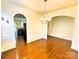 Dining room with an archway, hardwood floors, decorative wainscoting, and a view of the kitchen at 1923 Caprington Dr, Fort Mill, SC 29707