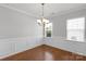 Elegant dining room featuring hardwood floors, wainscoting, and natural lighting at 1923 Caprington Dr, Fort Mill, SC 29707