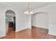 Elegant dining room with hardwood floors, archway, chandelier, and wainscoting detail at 1923 Caprington Dr, Fort Mill, SC 29707