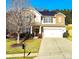 Attractive two-story home with a well-maintained lawn, complemented by solar panels on the roof at 1923 Caprington Dr, Fort Mill, SC 29707