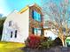 Beautifully landscaped yard surrounds this home with a stone facade and blue shutters on the windows at 1923 Caprington Dr, Fort Mill, SC 29707
