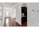 Open hallway with hardwood floors, archways, and view of a well-lit kitchen at 1923 Caprington Dr, Fort Mill, SC 29707