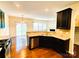 Bright eat-in kitchen featuring stainless appliances, dark cabinets, granite countertops and tile backsplash at 1923 Caprington Dr, Fort Mill, SC 29707