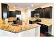 Modern kitchen featuring granite countertops, stainless steel appliances, and dark wood cabinets at 1923 Caprington Dr, Fort Mill, SC 29707