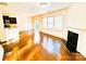 Bright living room featuring a fireplace, hardwood floors, and sliding doors to the backyard at 1923 Caprington Dr, Fort Mill, SC 29707