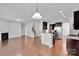 Spacious living room with hardwood floors, fireplace, and open access to the kitchen at 1923 Caprington Dr, Fort Mill, SC 29707