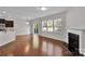 Bright living room featuring hardwood floors, fireplace, and access to the backyard at 1923 Caprington Dr, Fort Mill, SC 29707