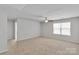 Large living room with neutral carpet, ceiling fan, and a bright, airy feel at 1923 Caprington Dr, Fort Mill, SC 29707