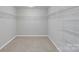 Spacious walk-in closet featuring ample shelving and carpeted floors at 1923 Caprington Dr, Fort Mill, SC 29707
