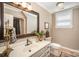 Well lit bathroom with a large vanity, dark accents, and window at 25 Blenheim Ne Ct, Concord, NC 28025
