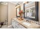 Bathroom features double sink vanity with granite countertops, and dual decorative mirrors at 25 Blenheim Ne Ct, Concord, NC 28025