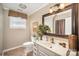 Bathroom with white vanity, neutral paint, and a decorative mirror at 25 Blenheim Ne Ct, Concord, NC 28025