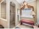 Bathroom features tiled shower, bench seat, decorative window treatment, and elegant chandelier at 25 Blenheim Ne Ct, Concord, NC 28025