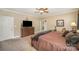 Bedroom features king bed, neutral walls, ceiling fan, and closet access at 25 Blenheim Ne Ct, Concord, NC 28025