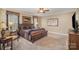 Bedroom features king bed, neutral walls, ceiling fan, and dark wood furnishings at 25 Blenheim Ne Ct, Concord, NC 28025
