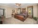Primary bedroom features king bed, neutral walls, ceiling fan, and decorative furnishings at 25 Blenheim Ne Ct, Concord, NC 28025