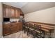 Bonus room with dark wood cabinets, countertop, and seating at 25 Blenheim Ne Ct, Concord, NC 28025