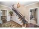 Grand foyer with a staircase, hardwood floors, chandelier, and elegant decor at 25 Blenheim Ne Ct, Concord, NC 28025
