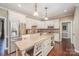 Modern kitchen features stainless steel appliances, an island with seating, and ample cabinet space at 25 Blenheim Ne Ct, Concord, NC 28025