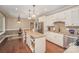 Open kitchen with island seating, stainless steel appliances, and hardwood floors at 25 Blenheim Ne Ct, Concord, NC 28025