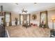 Spacious living room featuring neutral carpet, a ceiling fan, and classic decor at 25 Blenheim Ne Ct, Concord, NC 28025