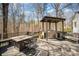 Outdoor kitchen on wooden deck with built-in grill, countertop, and dining area, perfect for entertaining in style at 25 Blenheim Ne Ct, Concord, NC 28025