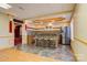 Basement bar area featuring custom tile work, ample seating, and modern appliances, ideal for hosting guests at 2846 Snead Ne Ct, Conover, NC 28613