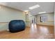 Spacious basement area with laminate floors and a large comfy chair, perfect for relaxation and entertainment at 2846 Snead Ne Ct, Conover, NC 28613